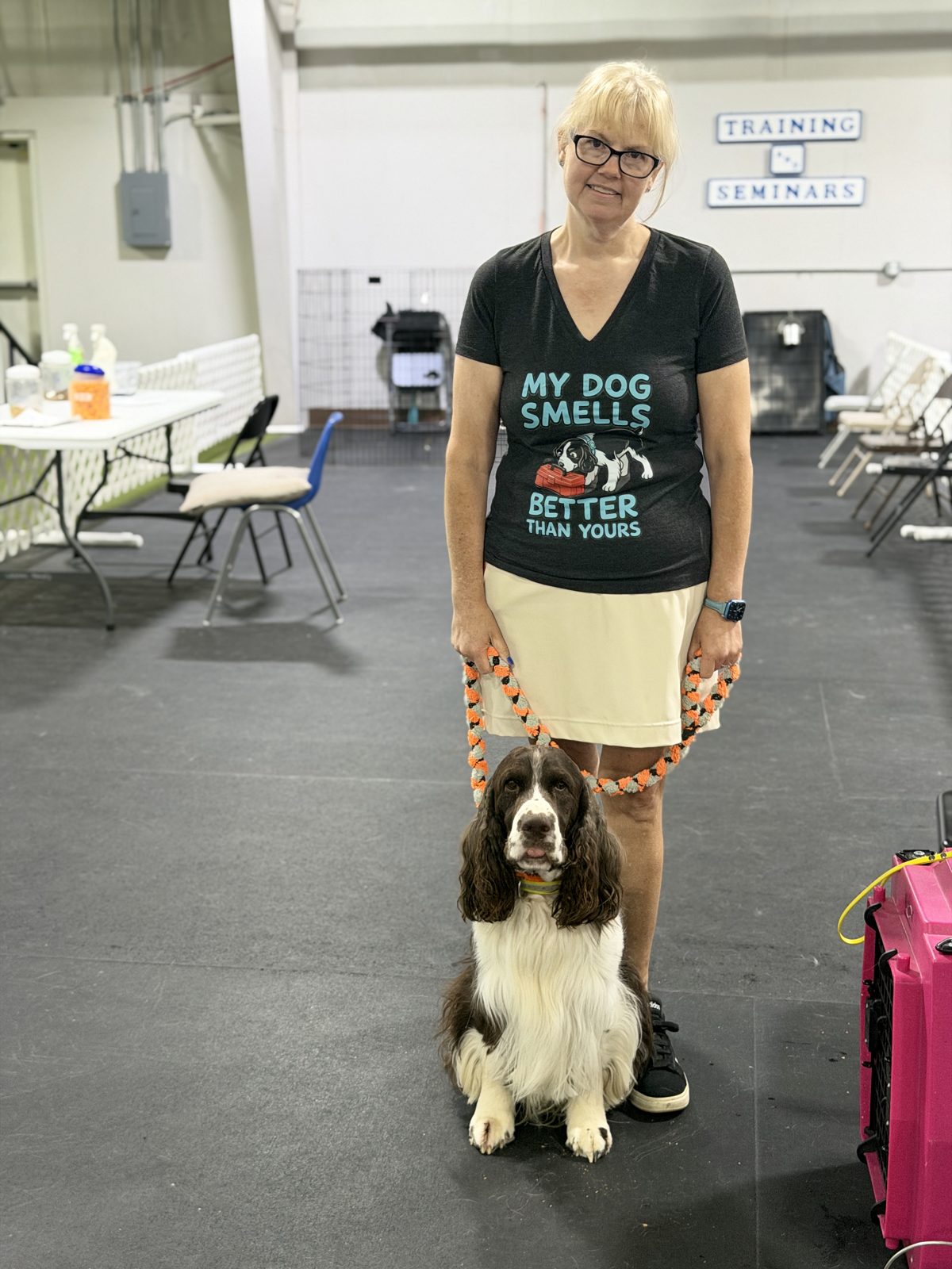 Terra standing with BlazE, a liver-and-white English Springer Spaniel, at WestInn Kennels